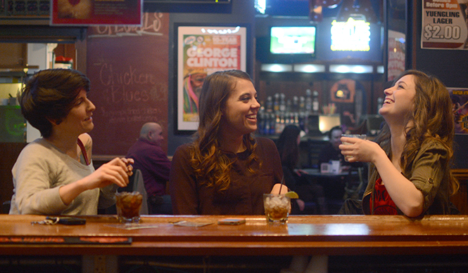 Kent State alumni Kat Kasee, Erika Knopsnider and Erin Duffy enjoy the $2 happy hour in Water Street Tavern on April 9, 2014.