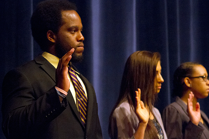 Kent State's new senator for Undergraduate Studnt Government Colin Otubu (left) swore into his position at Wednesday evening's Undergraduate Student Government Spring Leadership Awards on April 9, 2014.