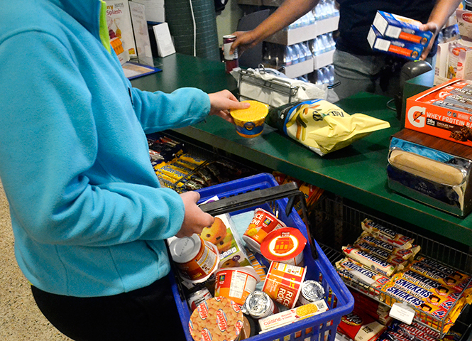 Freshman early childhood education major Emily Dame buys a full basket of food at Prentice Munchies using her meal plan, Monday, April 28, 2014.