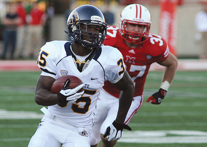 Kent State freshman running back Julian Durden runs the ball past Miami University senior linebacker Pat Hinkel in a game against Miami at Yager Stadium on Saturday, Nov. 10, 2012. Photo by Kristin Bauer.