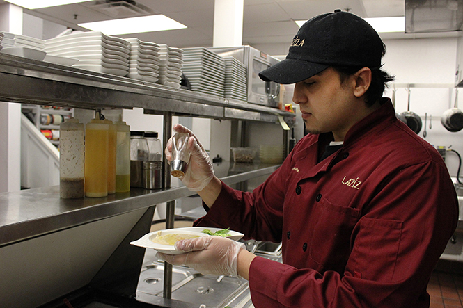 Cook Shaun Rizk prepares a plate of hummus at Laziza restaurant in downtown Kent, April 7, 2014. Laziza was voted best for its vegetarian selection.