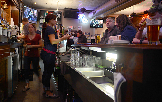 The Ray's Place staff keeps busy behind the bar Tuesday night during the Indians vs. Padres game, April 8, 2014.