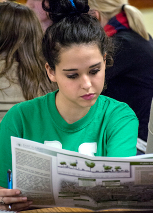 A student reviews project plans at the provost leadership academ