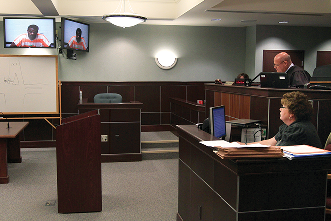 Judge Mark Fankhauser (right) presided the arraignment of Quavaugntay Tyler (on screen) at the Portage County municipal courthouse, Monday, April 7, 2014.