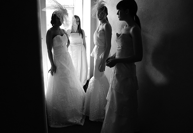 Models wearing a collection of student-made wedding gowns wait backstage during last spring's Kent Fashion Week showcase at 157 Lounge in Kent, Ohio on May 4, 2013.