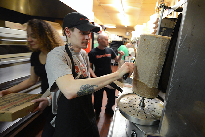 Euro Gyro cook Bill King shaves meat for a gyro Wednesday night, April 9, 2014. Euro Gyro took first place in Best of Kent's category best drunk food.