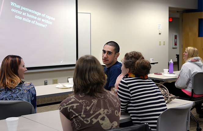 Senior psychology major Ben Mickey deliberates with his team during a game of sexual awareness jeopardy at the S.A.R.A. Speaks event Wednesday, April 9, 2014.