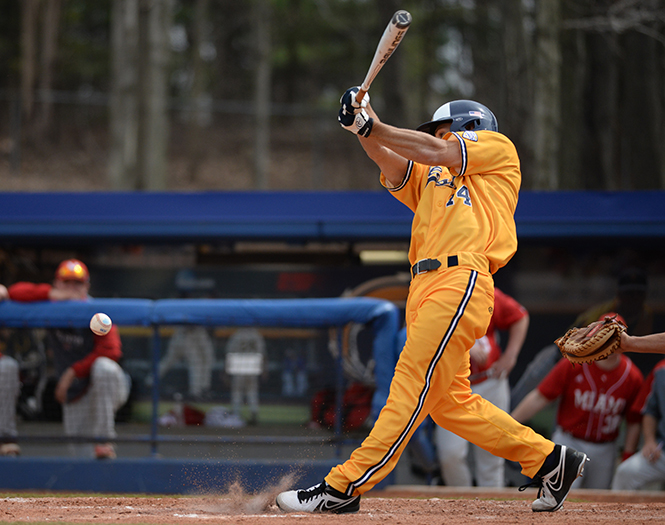 Junior infielder Sawyer Polen makes contact with a pitch at the game against Miami University Sunday, April 13, 2014. The Flashes played a three game tournament winning two out of the three games. They lost Sunday's game, 4-6.