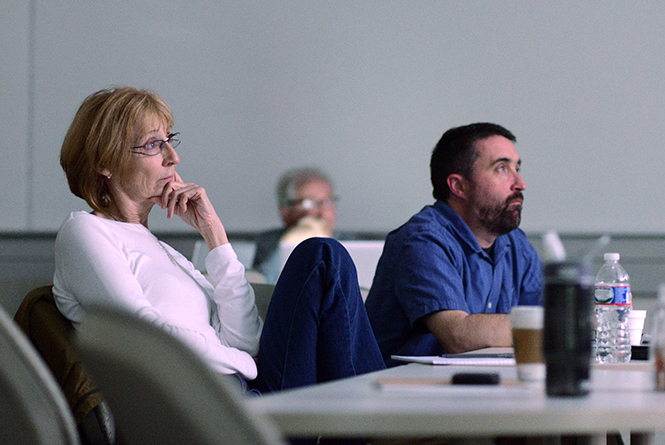 (From left) Assosicated press photographer and Kent State alumna Sue Ogrocki and photojournalism adviser for the University of Kentucky's student paper David Stephenson, view contest entires at the Ohio Newspaper Association's annual contest, held in Franklin Hall at Kent State, April 12, 2014. Several Kent students and alumni receives recognition in the contest. Submitted image from the Kent State NPPA blog.