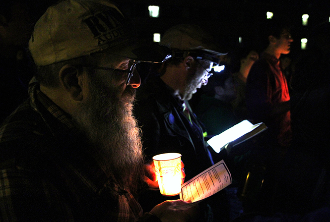 Timothy H. Simandl, 62, of Kent, joins in a Jewish prayer in remembrance of the four students killed during the Kent State Shootings in 1970 on Friday, May 3, 2013 outside Taylor Hall.