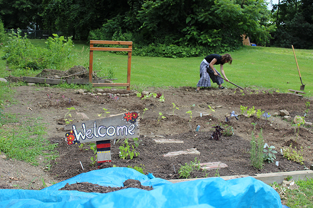 Nicholas Brouman works in the garden acoss from Holden Elemetry School in Kent on July 7, 2014.