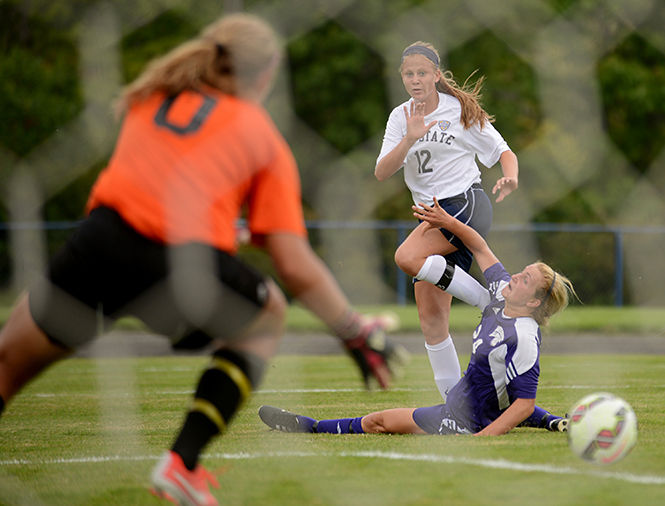 Kent State freshman Kristen Brots watches her shot against Western Illinois at the season opening game on Friday, August 22, 2014. The Flashes beat the Leathernecks 3-0.