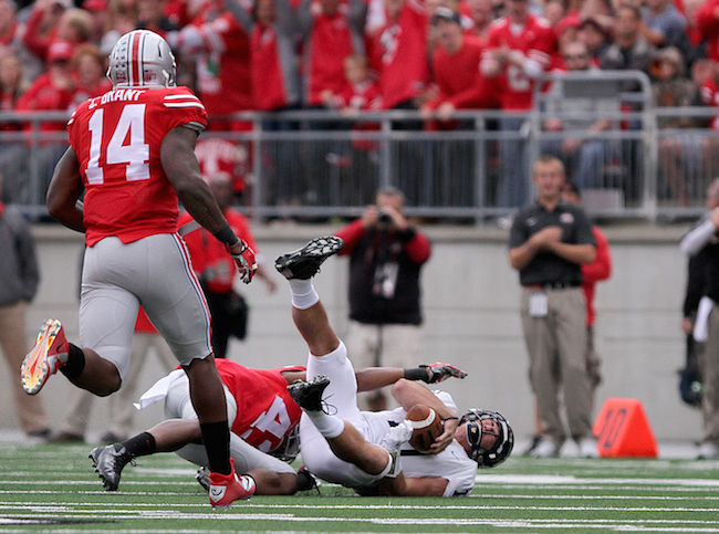 Colin Reardon, Kent State's quarterback, is sacked by an Ohio State defensive player at the Kent State vs Ohio State game Saturday, Sept. 13, 2014. Reardon was sacked three times throughout the game and the Flashes fell to the Buckeyes with a final score of 66-0.