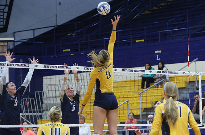 Senior middle blocker Liz Reikow jumps for return against The University of New Hampshire on September 6, 2014. The Flashes won the game 3-1.