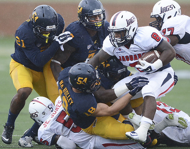 Kent State defensive linemen tackle University of South Alabama's Jay Jones at the football game September 6, 2014. The Flashes will take on The University of Virginia on Saturday.