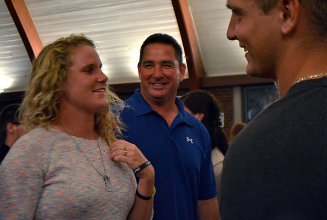 Ryan Bitsko (middle), the father of deceased Jason Bitsko, laughs with friends at the memorial service held in his honor on September 10, 2014. Bitsko drove three and a half hours to come for the hour long service from his home town of Huber Heights.