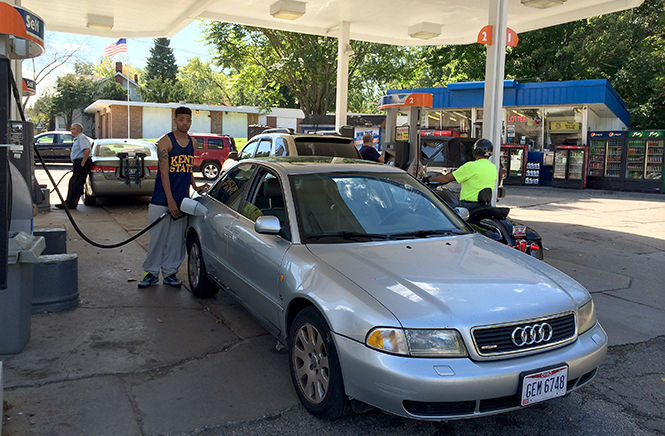 Robert Gay III, junior public communication major, fills up at the Gulf gas station at 706 S. Water on Sunday, Sept. 21.