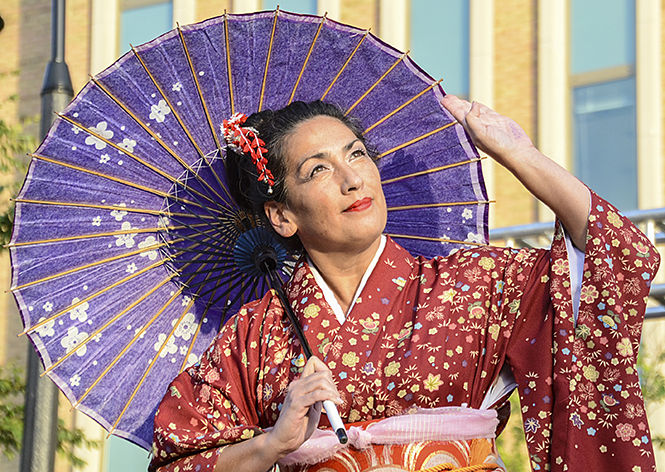 Pam Souza, 34, of the Sho-Jo-Ji Japanese dancers, performs a traditional Japanese dance at Asian Fest on Risman Plaza on Thursday, Sept. 25, 2014.