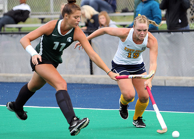 Kent State sophomore Madison Thompson tries to take the ball past Michigan State's Jenni Smith during a match Saturday, Sept. 13, 2014. Kent State lost 3-4 in overtime.