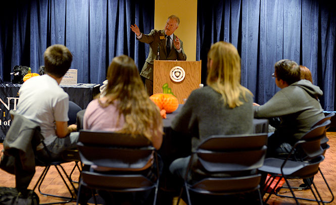 Robert Walker, director of the School of Digital Sciences, presents important faculty during the School of Digital Science's third birthday party Thursday, Oct. 30, 2014.