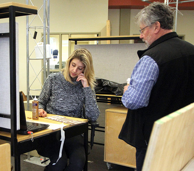 Architecture professor Charles Harker takes a look at senior architecture major Danielle Jones's project during her studio time Wednesday, Oct. 8, 2014.