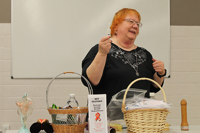 Kat Holtz, health educator and HIV specialist, teaches Kent State students about contraceptives and practicing safe sex at the "latexology" presentation as a part of Sex Week on Monday, Oct. 27, 2014.