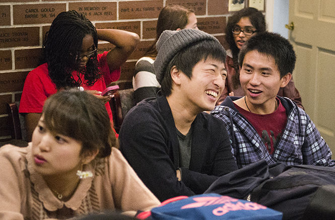 Toshiki Nakamura, a freshman English as a Second Language major from Japan, laughs with friends in the Kent State International Mentors program before KSIM's India night in the Williamson Alumni Center on Tuesday, Sept. 30, 2014.