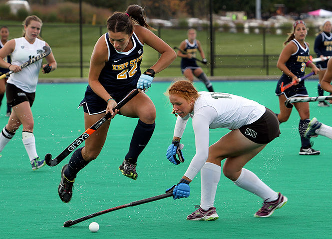 Kent State's Ines Delpech jumps over the stick of Ohio University's Vicky Nase while taking the ball down the field Saturday, Oct. 11, 2014. Kent State won 4-3.