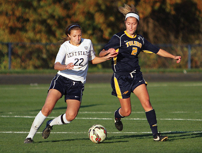 Freshman midfielder Abbie Lawson fights for the ball against Toledo's Megan Connor to the ball during a game Friday, October 24, 2014. The Flashes won 3-0.