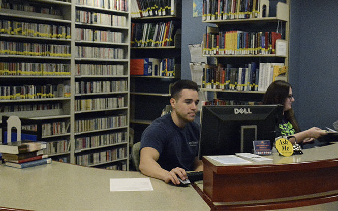 Patrick Markovich (left) and Sarah Holmes (right) work at the Performing Arts Library. Kent State's libraries have librarians in each department available to help students with research.