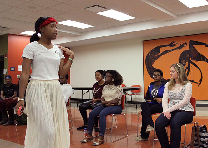 Sade Moose, a senior fashion merchandising major and president of Exquisite Inc. Modeling Troupe, demonstrates the proper runway walk to a model workshop on Monday, Oct. 13 2014.