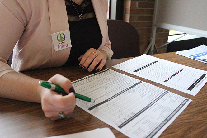 A counselor screens a volunteer who completed a personal survey on National Depression Screening Day. Depression screenings were done in the Student Center on Thursday, Oct. 9, 2014.