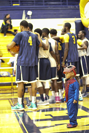 Two-year-old Kent resident Ramar Richmond, dressed as Spider-Man, plays on the gym floor of the M.A.C. Center during Hoops 'n' Halloween on Sunday, Oct. 26, 2014.