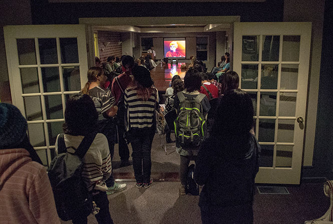 Students watch a presentation on the history and culture of Inda at KSIM's India Night in the Williamson Alumni Center on Tuesday, Sept. 30, 2014.