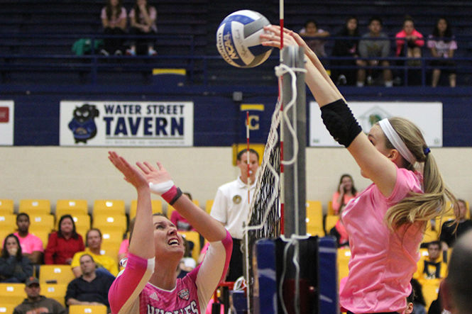 Freshman outside hitter Kelsey Bittinger from the Flashes blocks the ball against Northern Illinois at the annual 'Dig for the Cure' volleyball match at the MAC Center on October, 24, 2014.