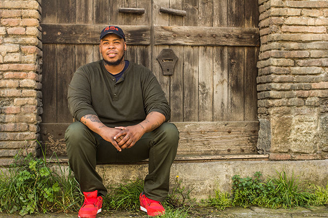 Terell Wilson, a senior applied communications major, sits on the steps of Cinecittá Studios, a film production studio in Rome, Italy, on Feb. 27, 2014.