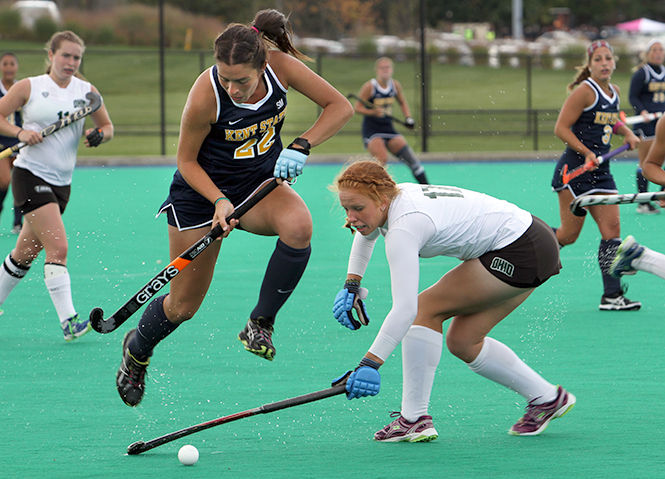 Freshman Ines Delpech jumps over Ohio University's Vicky Nase's stick while taking the ball down the field during the game Saturday, October 11, 2014. The Flashes won, 4-3.