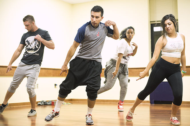 Rachael Le Goubin / The Kent Stater PJ Camargo, sophomore human movement major, leads a practice session for the members of Authentik in the Student Center Monday, Oct. 6, 2014. From left to right Brandon Lazenko, PJ Camargo, Miriam Yohannes and Sarah Restifo.