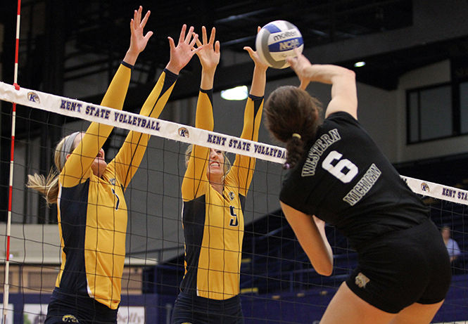 Kent State's junior Kelly Hutchison and senior Liz Reikow jump together to block the ball during a game against Western Michigan on Saturday, Oct. 25, 2014. The Flashes won, 3-1.