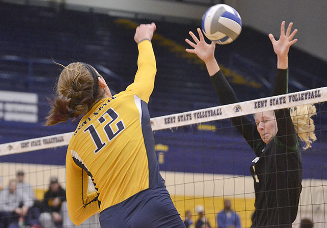 Kent State's senior middle blocker Bridget Wilhelm spikes the ball during the game against MAC opponents Ohio University in the M.A.C. Center on Thursday, Oct. 30, 2014. 