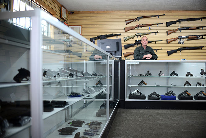 Sporting Defense LLC owner Larry John speaks to customers on Saturday, Jan. 12. John opened the gun shop in Brimfield, just outside of Kent, in August of 2012. Lately, John says sales have been higher than ever, especially since the gun control debate resulting from the recent school shootings in Connecticut.