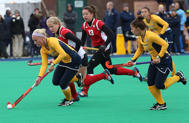 Sophomore forward Kyrsti Lober runs the ball against Miami University at the game Friday, Nov. 7, 2014. The Golden Flashes won the game 3-1.