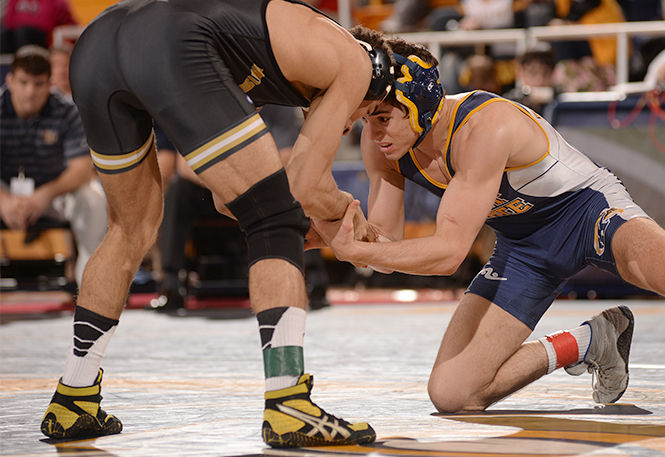 Kent State's Tyler Small wrestles against Lavion Mayes from the University of Missouri at the MAC Championship meet hosted by Kent State on Saturday, March 8, 2014. Small lost 4-2 in overtime.