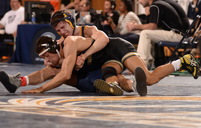 Kent State's Tyler Small wrestles against Lavion Mayes from the University of Missouri at the MAC Championship meet hosted by Kent State on Saturday, March 8, 2014. Small lost 4-2 in overtime.