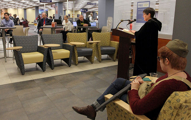 Library reference services staff member Joy Leavy reads "The Masque of the Red Death" by Edgar Allan Poe during the Halloween Kent Reads program in the library Wednesday, Oct. 29, 2014.