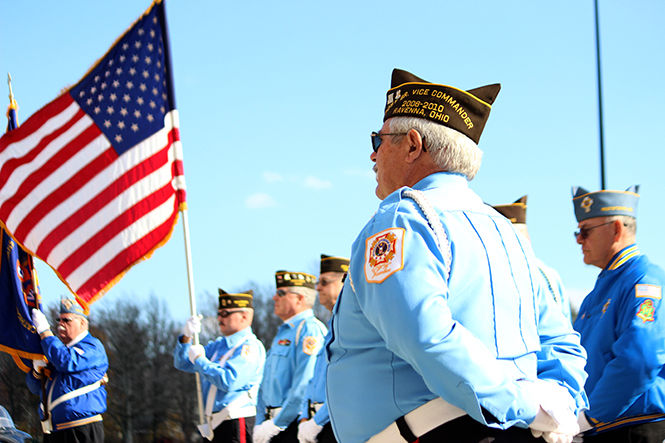 Veterans in uniform raise the flag during a Veteran's Day ceremony hosted by PARTA and the Kent State University Hotel and Conference Center on Veterans Day, Tuesday Nov. 11, 2014.