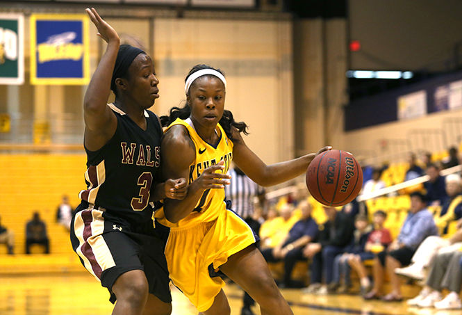 Kent State guard Ashley Evans deflects Walsh University’s Jalynn Graham during the Wednesday, Nov. 6, 2013 game in the M.A.C. Center. The Flashes lost the exhibition game 80-89.