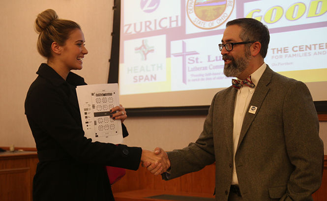 Madison Davis, (on left) a senior health care administration major, speaks with Sam Rubens, the administrator of the Akron Regional Air Quality Management District.