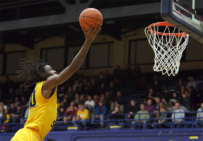 Sophomore forward Marquiez Lawrence goes for the net during a game against Toledo in the M.A.C. Center on Wednesday, Jan. 21, 2015. The Flashes beat the Rockets, 67-60.