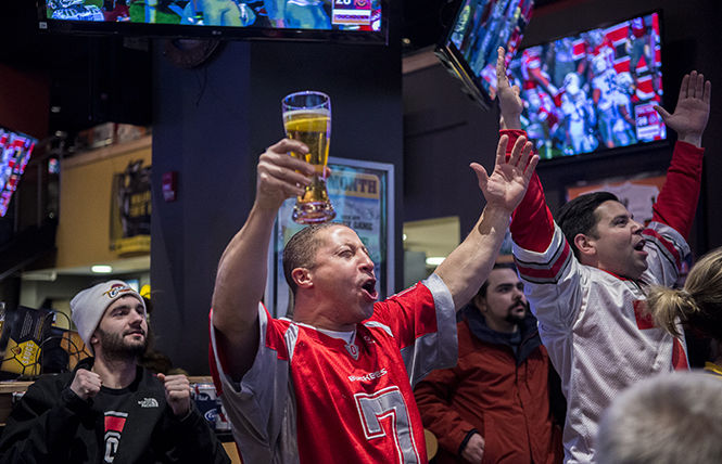 Buckeye fans Jay Love and Devlin Charlton celebrate as they watch Ohio State score a touchdown in the third quarter of the 2015 National Championship game against Oregon on Monday, Jan. 12, 2015. The Buckeyes won the game 42-20.